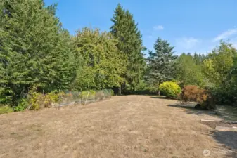 You’ve got 1.35 acres here, with about an acre of pasture stretching below the house. Up top there’s a fenced garden area and fruit trees sprinkled around, so you can grow veggies, bake pies, or just brag that you have your own orchard.