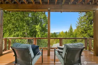 Covered deck on first lower level with view of the lake