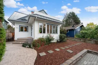 Nicely landscaped with pavered entry and concrete porch.