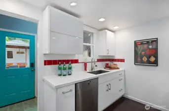 Mudroom adjacent to the kitchen leads to the back yard.