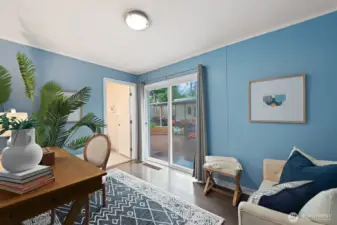 The den on the main level offers another access to the back yard and huge deck. The door, center of the photo, leads to a newly refurbished bath room.