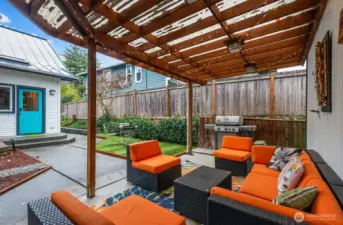 Easy living in this back yard. Huge covered patio adjacent to the garage. The garage is currently housing a climbing wall but could easily be converted back.