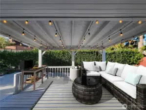 Upper level patio off kitchen. Enjoy a relaxing covered outdoor year-round oasis. (Staged to Scale)