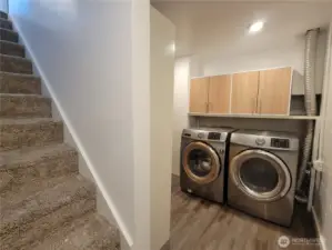 Utility area on lower level with storage joins the two levels of living.