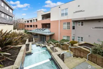 Looking down from the 1st gate. Look at the water falls parallel to the steps down to security gate #2. Once inside the gate a left turn to the end of the building to unit 207.
