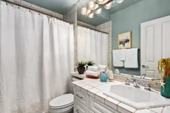 The main full bath very nice tile on the counter.