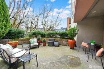 Let's step out of the living room door East thru the expansive patio. Raised garden beds surround the patio. Pots will stay with new owners if they would like them.