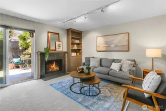 Family room with wood burning fireplace and access to fenced backyard with deck. New paint and carpet throughout