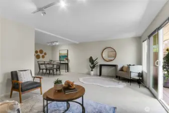 Family room with wood burning fireplace and access to fenced backyard with deck. New paint and carpet throughout