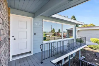 Front door on the upper level with a nice deck space giving you a great view of the Sound