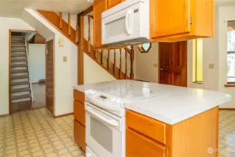 View of living room entry (camera left) and stairs to additional loft space.