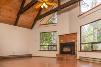 Living room with wood burning fireplace.