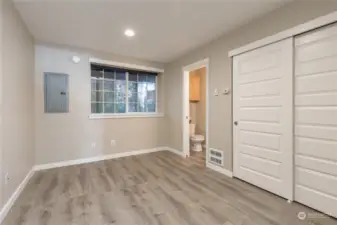 Bedroom with half bath behind the garage. Brand new flooring and paint!