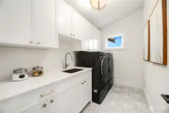 Upper Laundry Room with Sink & Ample Storage.