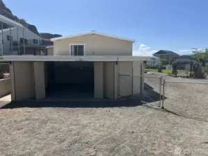 View of the house with the garage doors open.