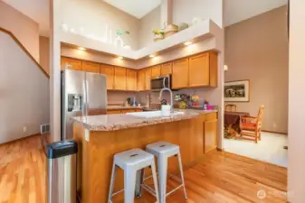 Kitchen includes a breakfast bar and is located in the center of the home.