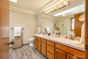 Primary 5 piece bath that was recently remodeled with new flooring, tile and frame less shower surround.