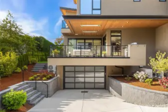 Sprawling 1200 SF garage with custom epoxy flooring tucked under the residence. Also notice the cedar celing detail with recessed heaters covering the 400 square foot deck off the great room