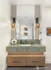 Custom floating slab counter with full height tile mirror surround in main floor 3/4 bath off the den