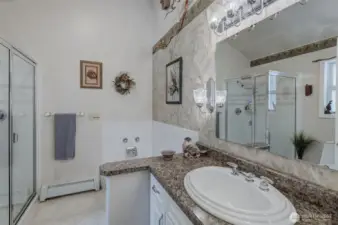 Main bath is modern, spacious and airy with vaulted ceiling, oversized walk-in shower, and soaking tub.