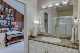 Vanity in primary bath, looking toward feature wall in primary suite