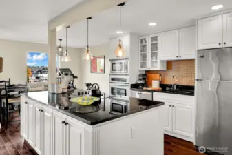 Wow, look at this kitchen! Huge island with storage, updated cabinetry and lighting, granite countertops!