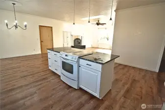 Kitchen looking onto dining, living room and wood fireplace