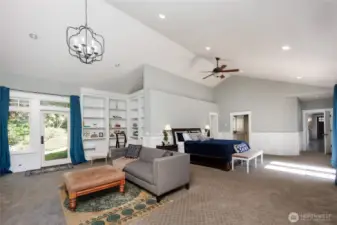 MAIN floor Primary Suite offers a fireside living room, library & dual walk-in closets.