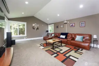 Oversized recreation/theater room with a walk-out back yard.