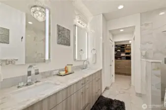 This primary ensuite is elegant, spacious and bright. Quartzite countertop, custom chandelier, internally lighted mirrors and heated floors.