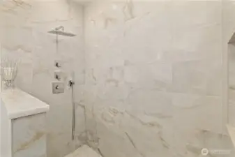 The primary ensuite boasts an oversized shower with large-format porcelain tile.