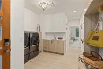 The mudroom is off the garage and also has an entrance from the driveway. Great storage and room for all your needs. LG Signature large washer and vented dryer. The walk in pantry is next to the primary entrance.