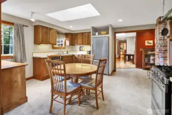 Kitchen with skylight and windows makes for a bright kitchen with dining area. Stainless steel appliances with a gas range.