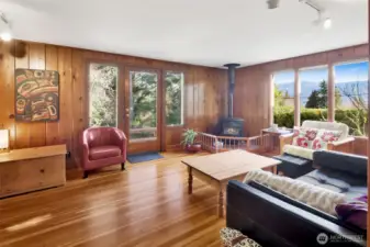 Family Room with Lake Whatcom views and free standing gas stove to cozy up to on those cold winter evenings. Original fir floors and knotty pine walls is warm and inviting.