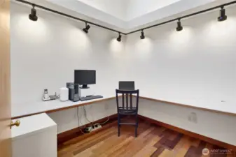Office located off the family room and hallway to the bedrooms. Large skylight provides for a light filled office with plenty of built in desk space.