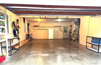 Oversized attached two car garage with door into the family room and separate door to the back yard.