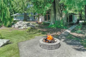 In your backyard you will find a quality firepit with large stone seating, water feature and pond. All beautifully landscaped.