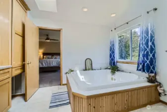 En suite bath with spa dbl jetted tub/  stand alone Shower and private commode room.