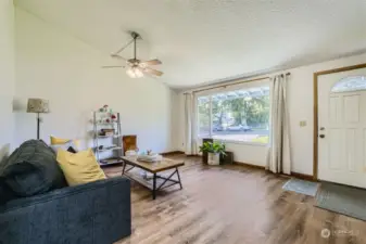 Living room is a comfortable  living space and offers large bay window, two art size walls and coat closet.  Main floor recently replaced with new LVP wood flooring.