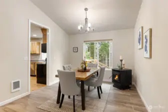 Dining room just off the kitchen features an energy efficient pellet stove.