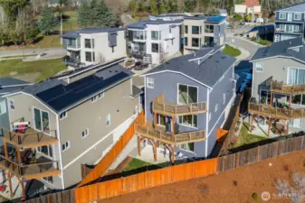 Views of both decks and fenced backyard.