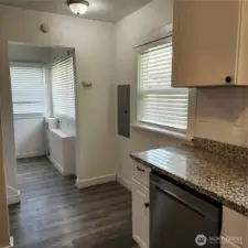 Another angle of the kitchen leading to the back door and laundry room