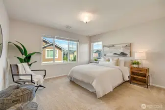 The primary bedroom features abundant space, a walk-in closet, and a spa-like ensuite with dual sinks, modern finishes, and a walk-in shower.