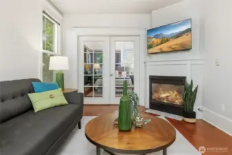 Cozy gas fireplace.  French Doors lead into the Primary Bedroom.