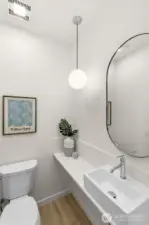 Powder room with refined finishes and polished fixtures adds convenience.