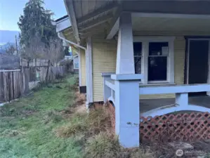 View from front of house, left side yard. Fully fenced lot.