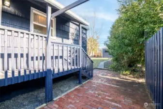 Kitchen window view & covered deck overlook patio pad.