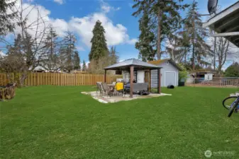 Large private backyard with pergola/barbecue area.