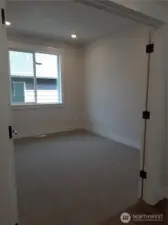 2nd floor bedroom at the top of the stairs easily functions as an open bonus area with double door entry.