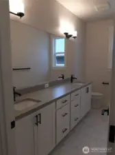 Large hall bath features dual vanity.